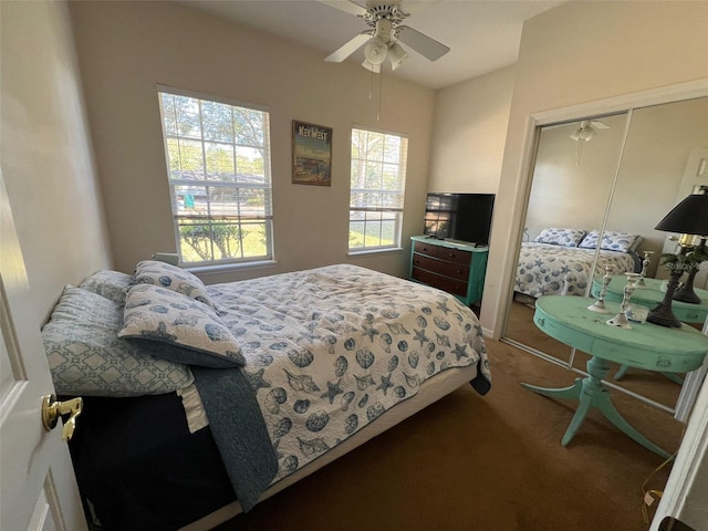 bedroom with ceiling fan, carpet flooring, and a closet