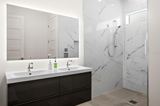 bathroom featuring tiled shower and vanity