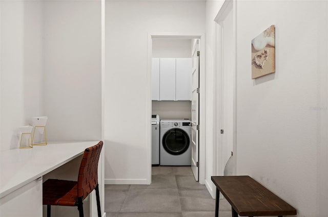 washroom featuring cabinets and washing machine and clothes dryer