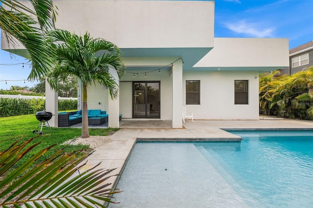 view of pool with an outdoor living space and a patio