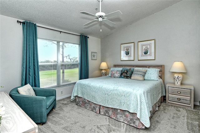 carpeted bedroom with ceiling fan, lofted ceiling, and a textured ceiling