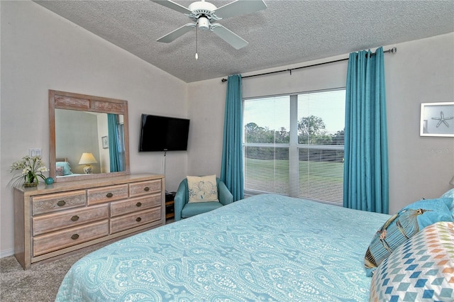 carpeted bedroom featuring vaulted ceiling, ceiling fan, and a textured ceiling