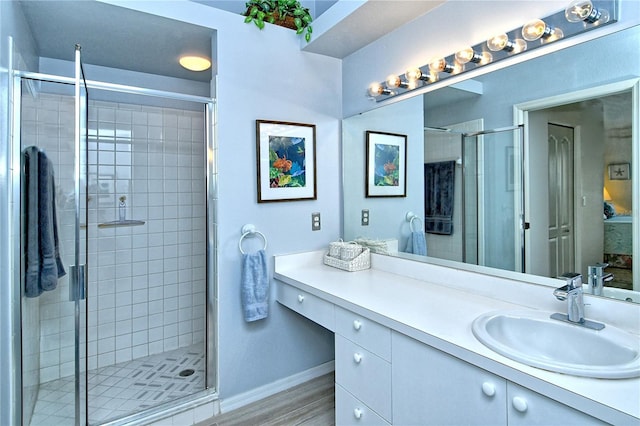 bathroom with vanity, wood-type flooring, and a shower with shower door