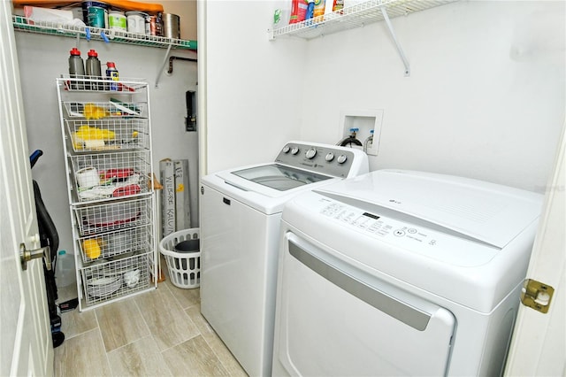 washroom with washing machine and clothes dryer