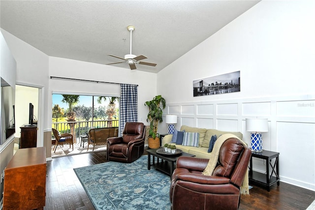 living room featuring ceiling fan, dark hardwood / wood-style flooring, high vaulted ceiling, and a textured ceiling