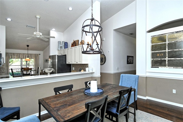 dining area with lofted ceiling, dark hardwood / wood-style flooring, and ceiling fan