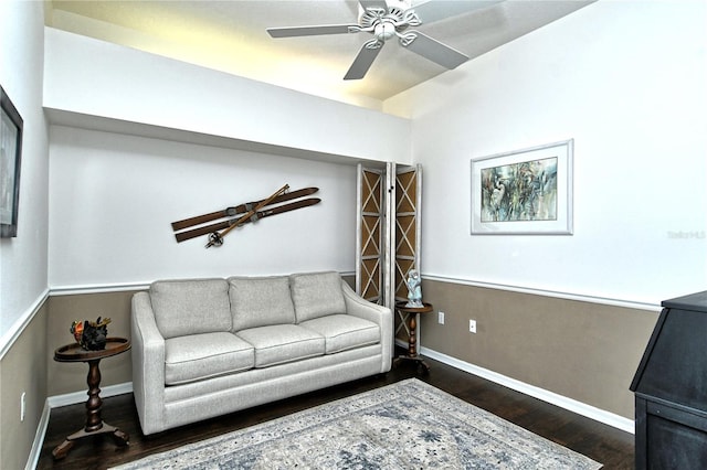 living room featuring dark hardwood / wood-style flooring and ceiling fan