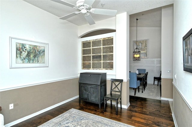 home office with dark hardwood / wood-style floors and ceiling fan