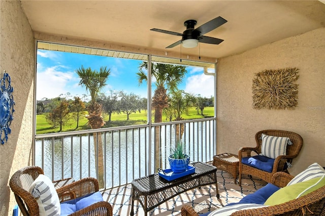 balcony with a water view and ceiling fan