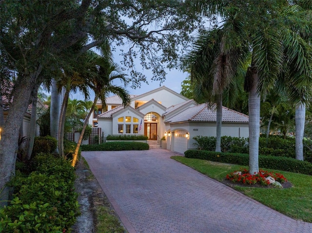 mediterranean / spanish house with a garage