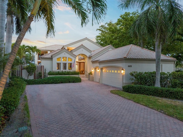 mediterranean / spanish-style house featuring a garage