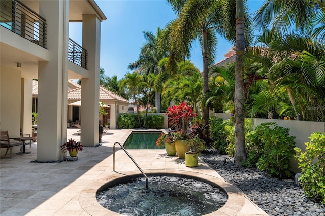 view of swimming pool with an in ground hot tub and a patio