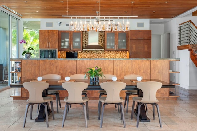 dining room with light tile patterned floors and wood ceiling