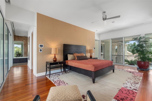 bedroom featuring access to exterior, wood-type flooring, and ceiling fan