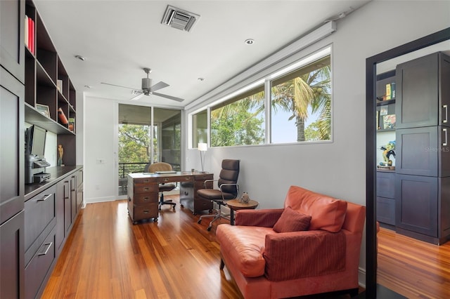 office space with ceiling fan and light hardwood / wood-style floors