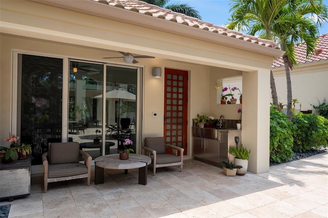 doorway to property featuring ceiling fan and a patio area