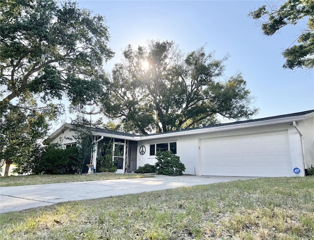 ranch-style home with a garage and a front yard