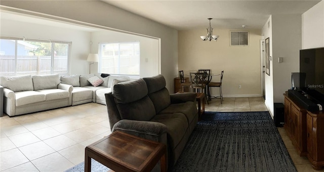 tiled living room featuring a notable chandelier