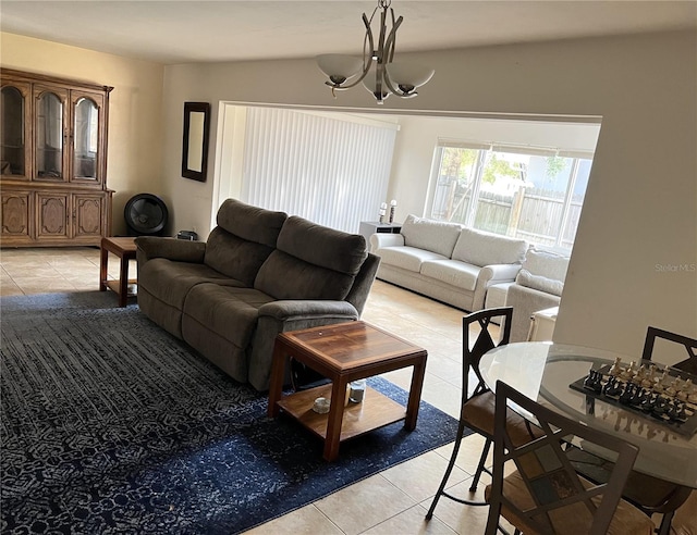 tiled living room with a notable chandelier