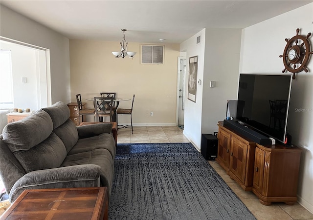 living room featuring light tile patterned flooring and a notable chandelier