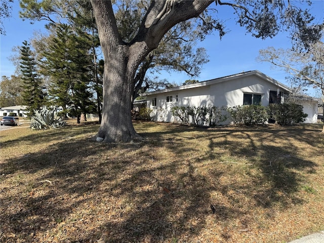 view of side of property with a yard