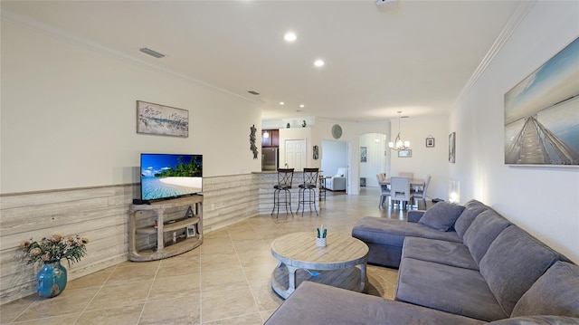 living room featuring crown molding, a notable chandelier, and light tile patterned floors