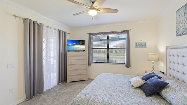 carpeted bedroom with ceiling fan and ornamental molding