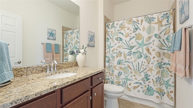 bathroom featuring tile patterned floors, vanity, toilet, and curtained shower