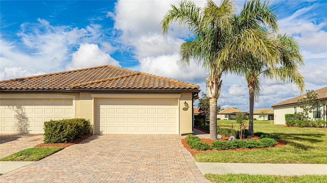 view of side of home with a garage and a lawn