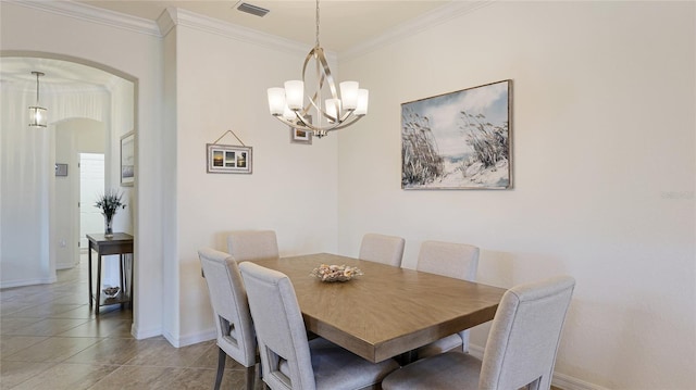 tiled dining space with ornamental molding and a chandelier