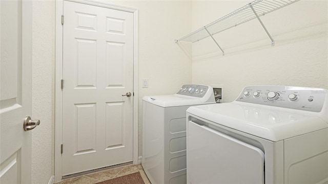 laundry area with tile patterned floors and washer and clothes dryer