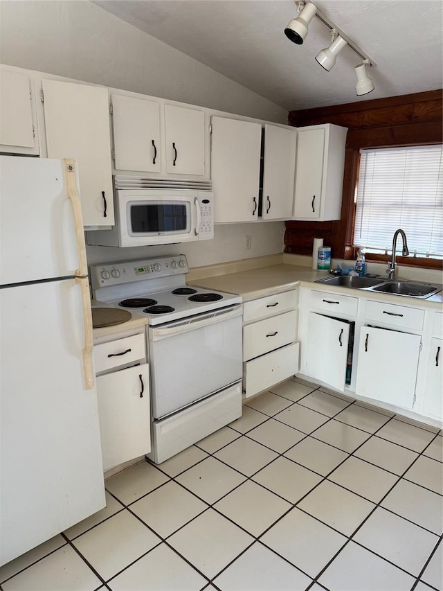 kitchen featuring lofted ceiling, sink, white appliances, and white cabinets