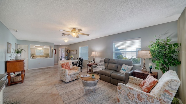 tiled living room featuring a textured ceiling and ceiling fan