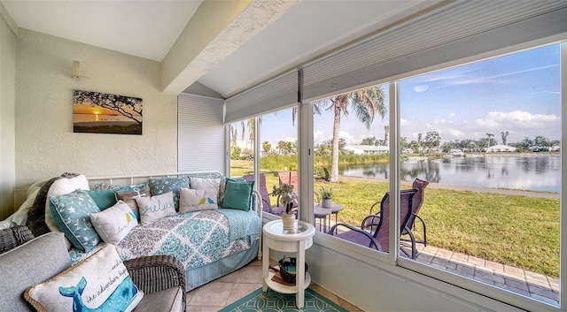 sunroom featuring a water view