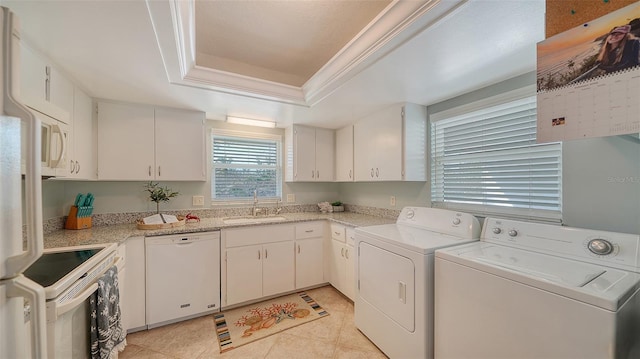 laundry room featuring washing machine and dryer, sink, light tile patterned flooring, and ornamental molding