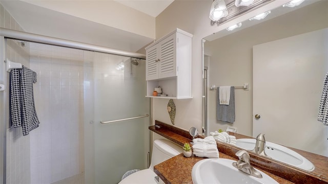 bathroom with vanity, toilet, and walk in shower