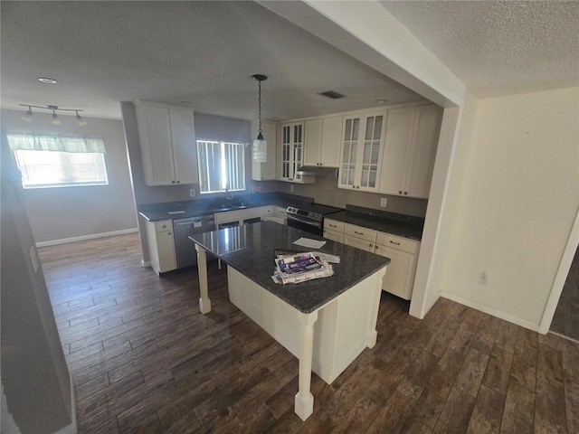 kitchen featuring a breakfast bar, white cabinetry, a center island, range with electric stovetop, and pendant lighting