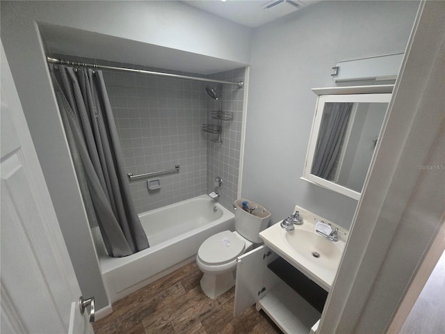 full bathroom with shower / tub combo, vanity, hardwood / wood-style flooring, and toilet