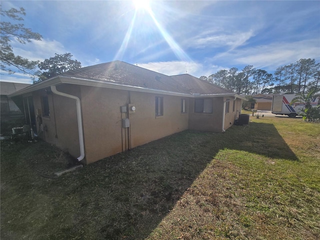 view of property exterior with a yard