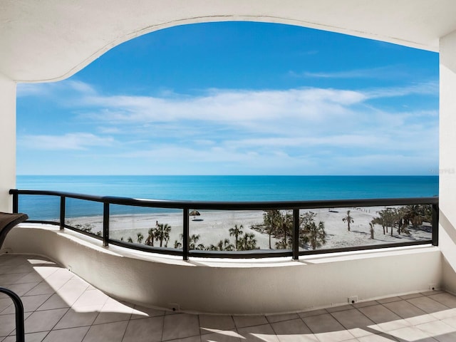 balcony featuring a water view and a beach view