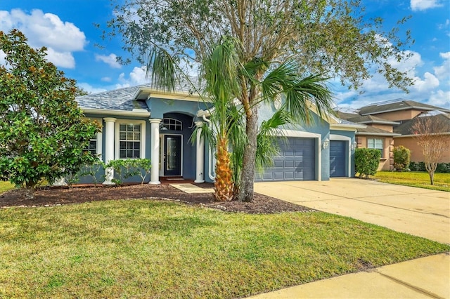 ranch-style house featuring a garage and a front lawn