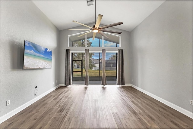 spare room with ceiling fan, high vaulted ceiling, and hardwood / wood-style floors