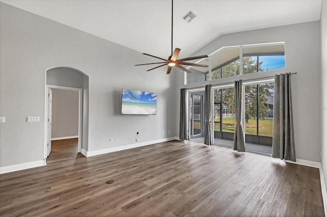 unfurnished living room with dark wood-type flooring, high vaulted ceiling, and ceiling fan