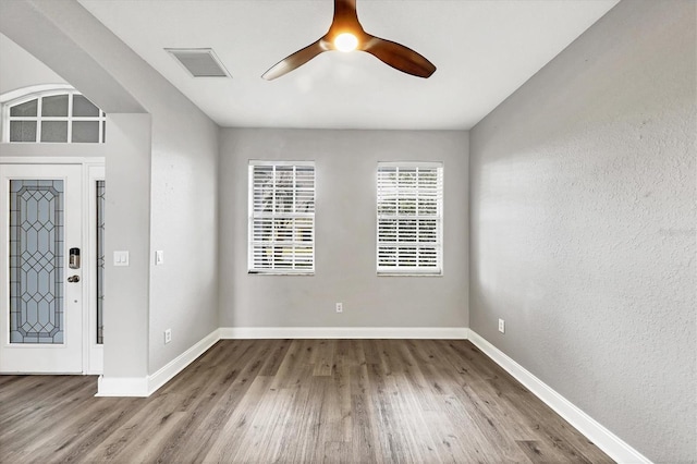 foyer entrance with hardwood / wood-style flooring and ceiling fan