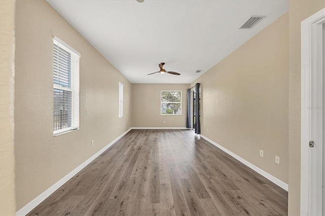 spare room with ceiling fan and wood-type flooring