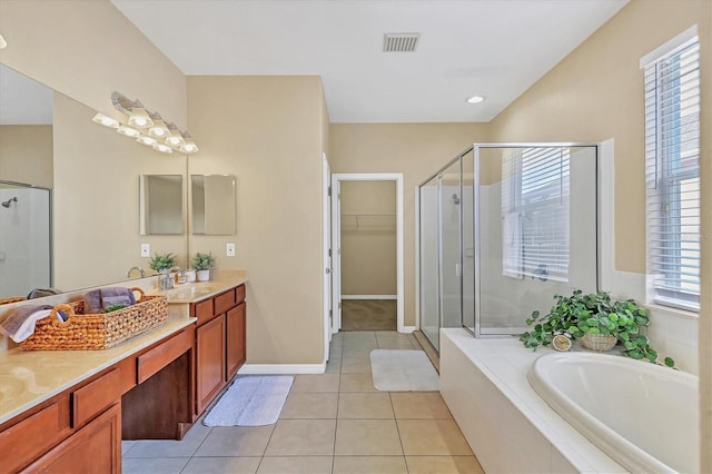 bathroom featuring tile patterned flooring, vanity, and shower with separate bathtub