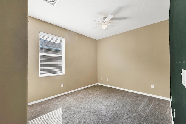 carpeted spare room featuring ceiling fan