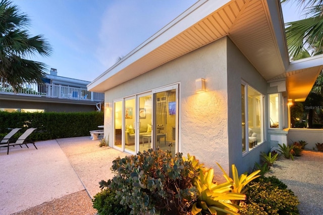 view of side of home with a patio area