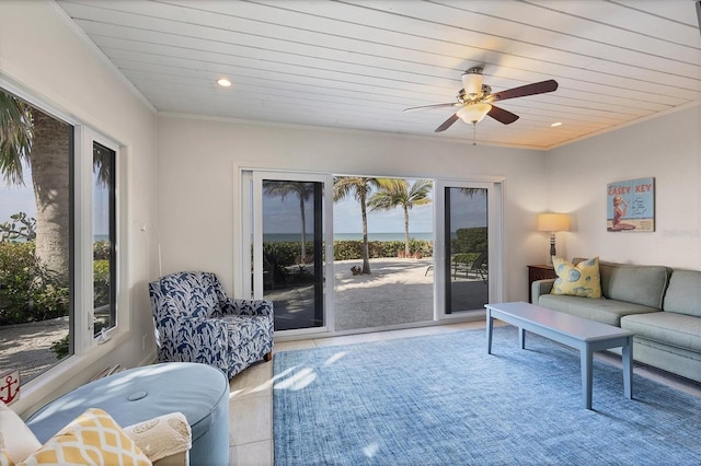 living room with ornamental molding and ceiling fan