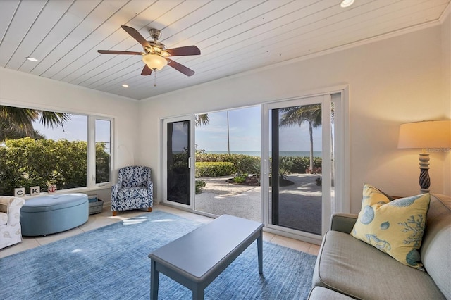 tiled living room with ceiling fan, ornamental molding, and wooden ceiling